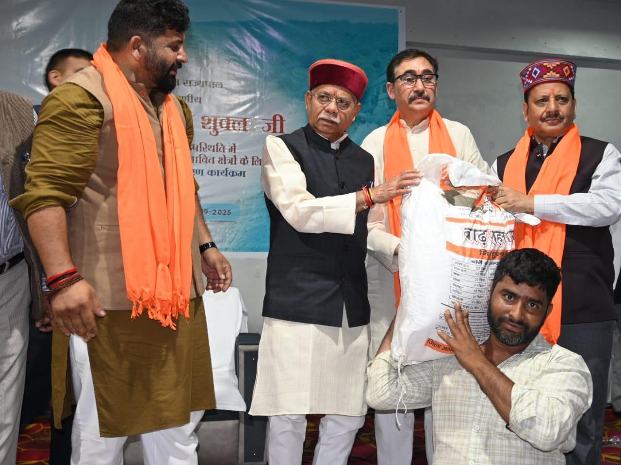 Himachal Governor distributes relief material among flood-hit