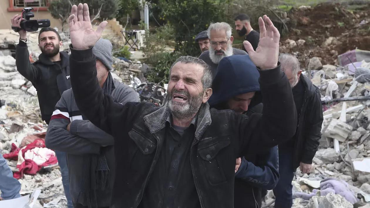 A civilian reacts next to his house, destroyed by an Israeli airstrike in South Lebanon.