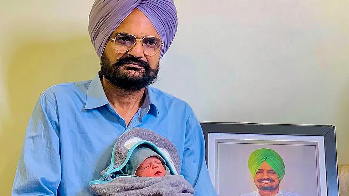 Balkaur Singh, father of Punjabi singer Sidhu Moosewala, with his newborn baby