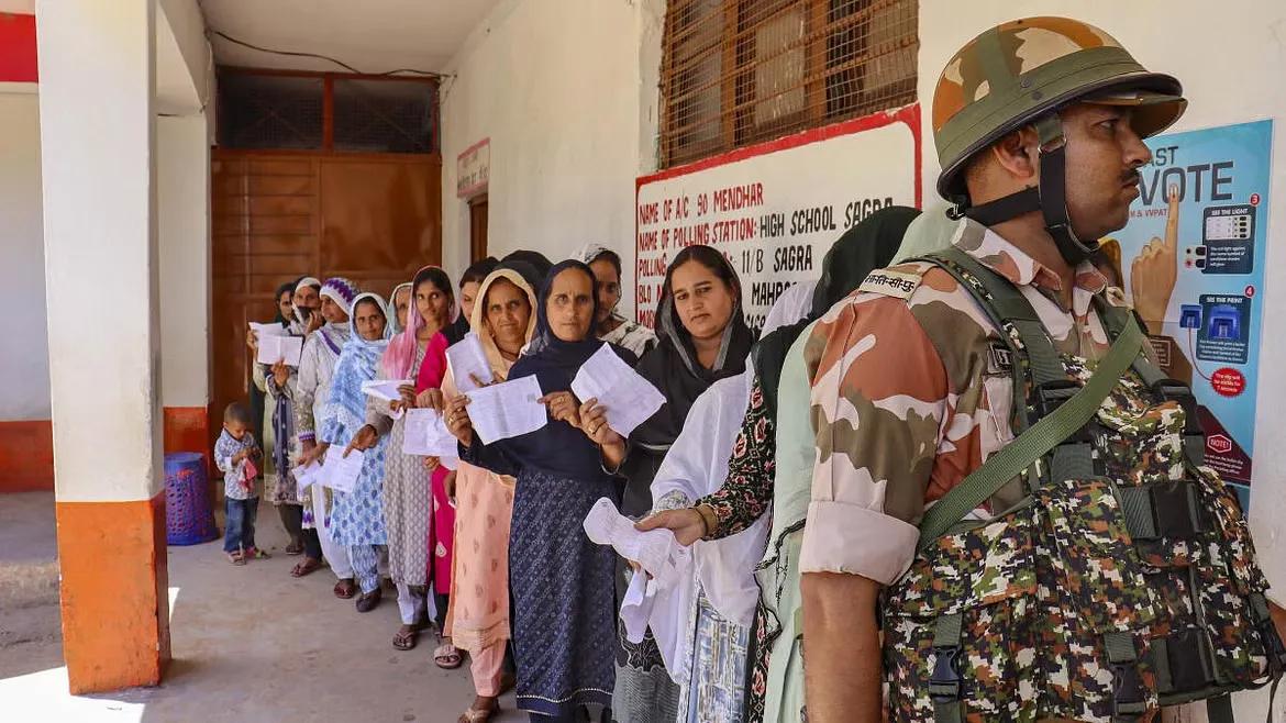 People wait in a queue at a polling station