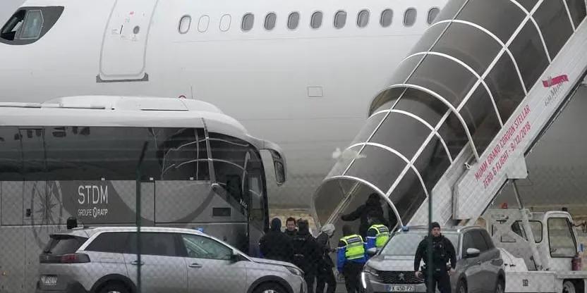 Men board the plane grounded by police at the Vatry airport , Monday, Dec. 25, 2023 in Vatry, eastern France (Credit: AP Photo)